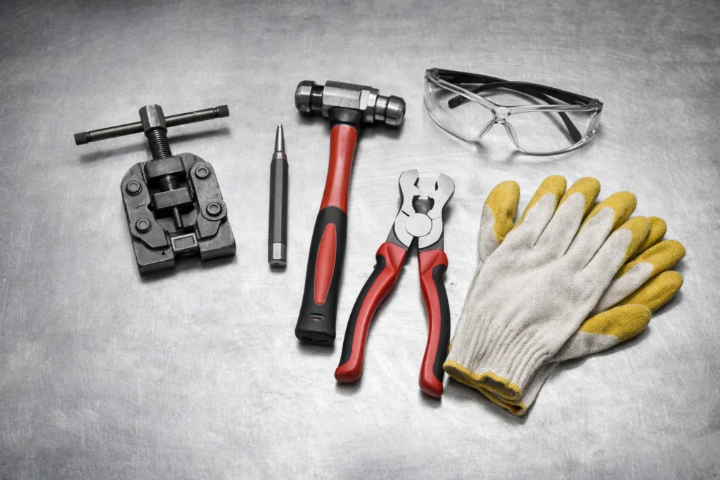 Tools required to remove chain links safely including chain breaker and master link pliers