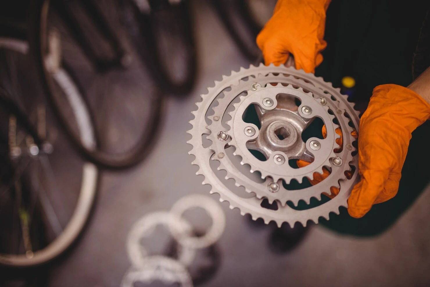 mechanic holding bicycle gear